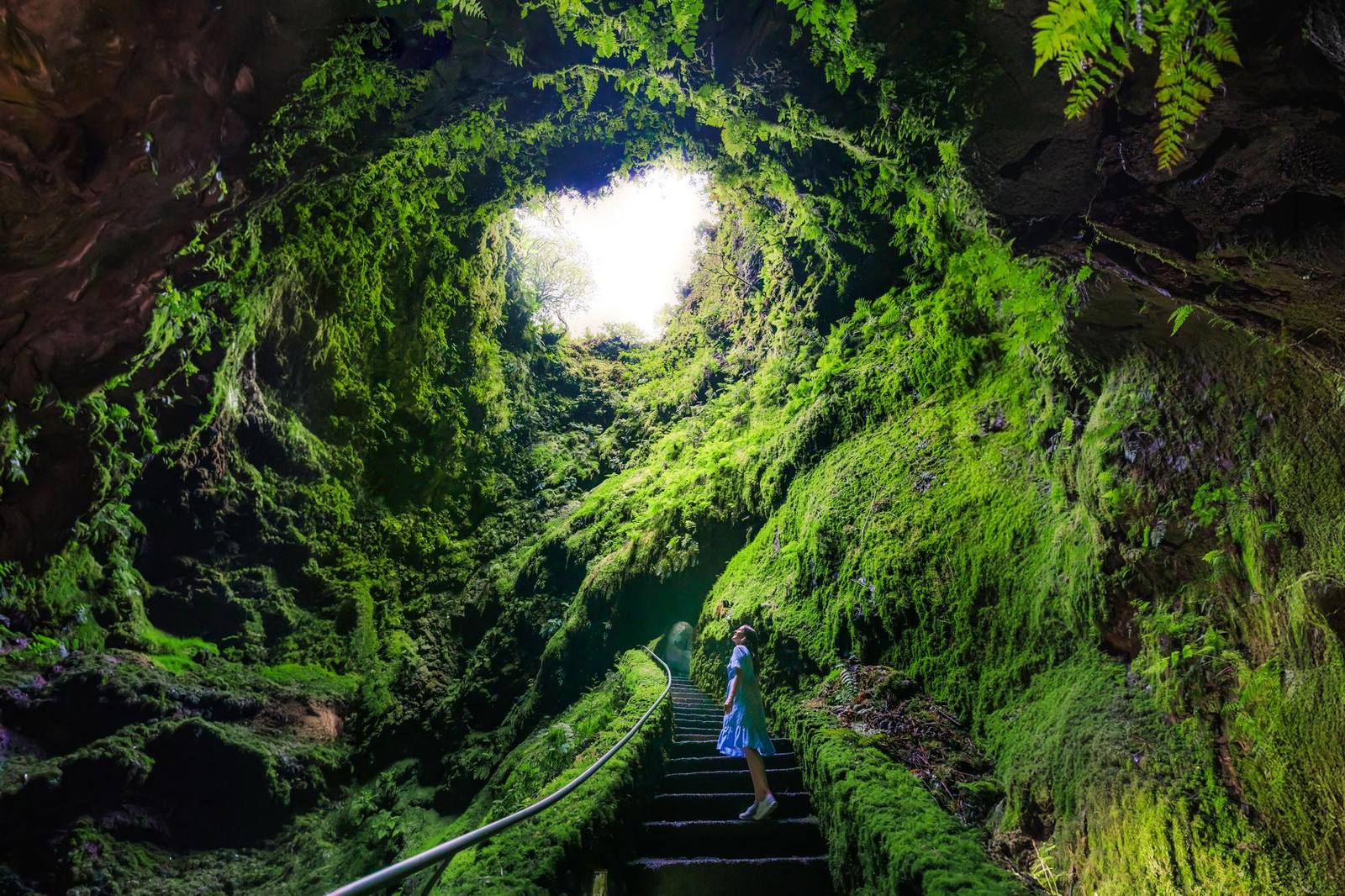 A mossy volcanic cave opening to the sky on Terceira, Azores