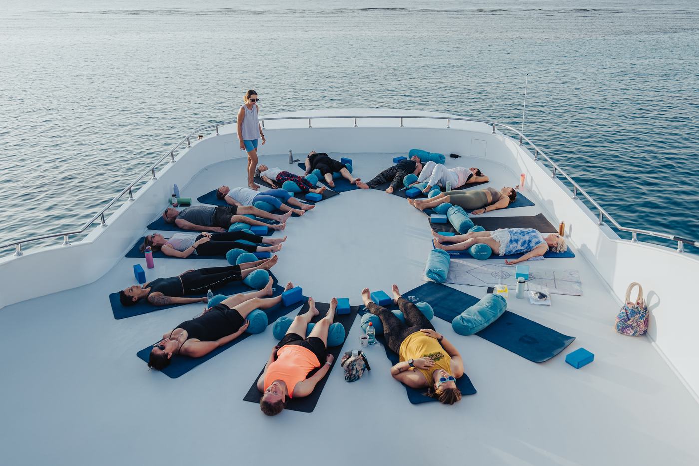 Guests in savasana on the top deck at sunset